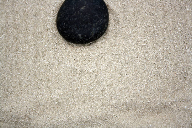 istock Sea round stones on the fine sand. Selective focus. 1339985196