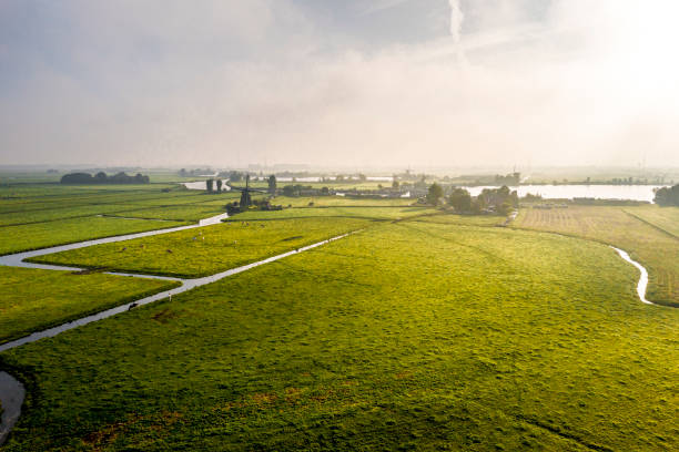 amanecer sobre el típico paisaje de pólder holandés con molinos de viento y prados - dutch culture windmill landscape netherlands fotografías e imágenes de stock
