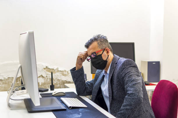 istock Businessman resting at his desk with mask 1339988304
