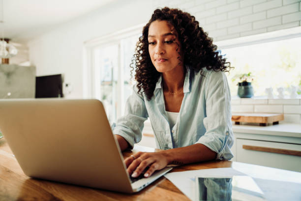 istock Mixed race female student working from home typing on laptop keeping up to date 1339989363