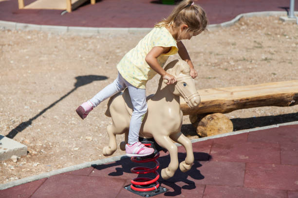istock Little Girl Playing At Playground 1339991106