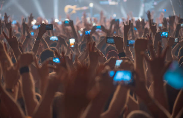 people at the concert with the phones stock photo