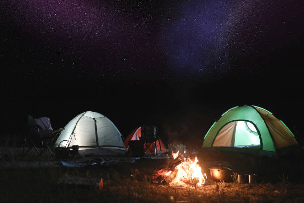 istock Bonfire near camping tents outdoors at night 1339991477