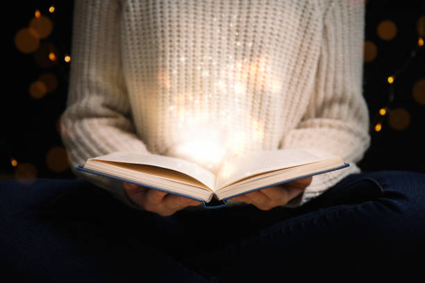 istock Woman with magic book, closeup. Fairy tale 1339992040