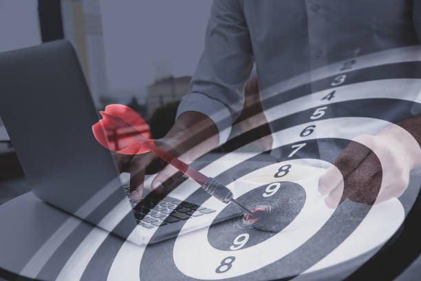 istock Businessman working with laptop and dart board. Double exposure 1339992072