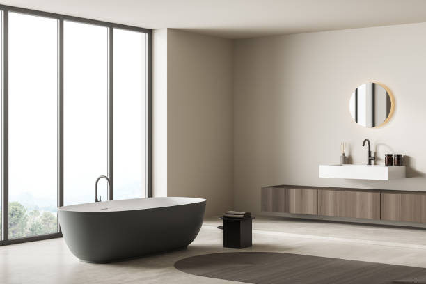 istock Bright bathroom interior with bathtub, panoramic window, carpet, concrete floor 1339993952
