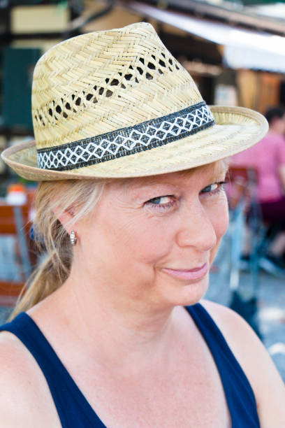 istock Beautiful blonde lady with sun hat 1339995586