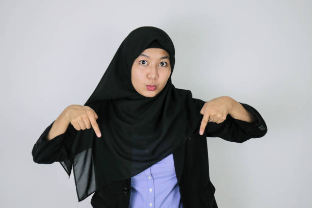 istock Shock asian islamic business women pointing below 1339995759
