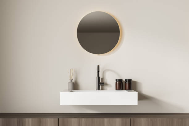 istock Bright bathroom interior with sink and round mirror 1339995902