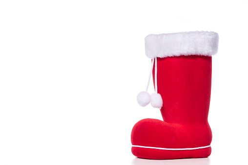 A red Santa boot with white tassels against a white background