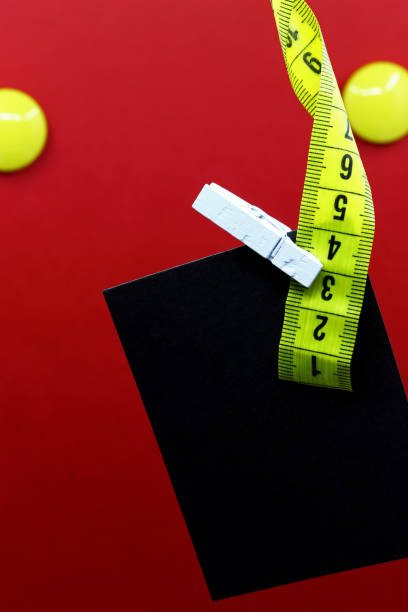 istock tape measure and note paper on a red background 1339997108