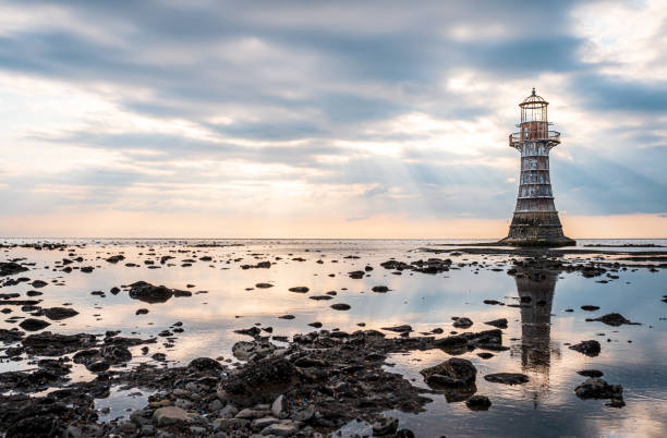 Whiteford Point Lighthouse at sunset, Swansea, Wales GB UK Whiteford Point Lighthouse near Whiteford Sands at sunset, the Gower peninsula, Swansea, South Wales, the United Kingdom lighthouse lighting equipment reflection rock stock pictures, royalty-free photos & images