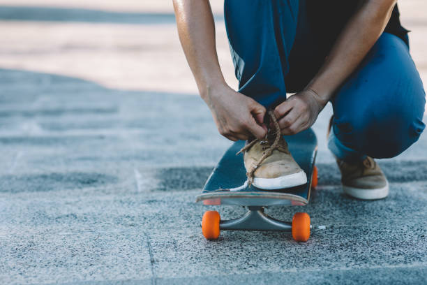 istock Skateboarder tying shoelace at outdoors 1340003702
