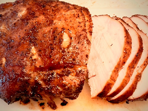 Carved smoked turkey meat. Slices of white meat.