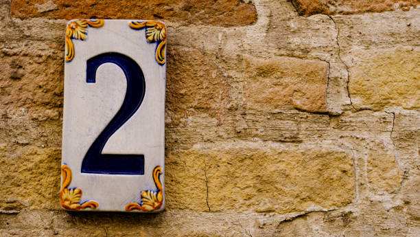 istock two. civic detail on yellow brick wall. number 1340005907