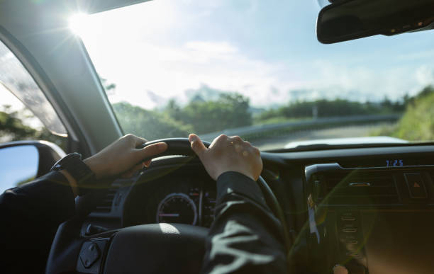 istock People driving car on sunrise mountain road 1340007210