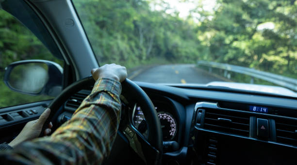 istock People driving car on sunrise mountain road 1340007414