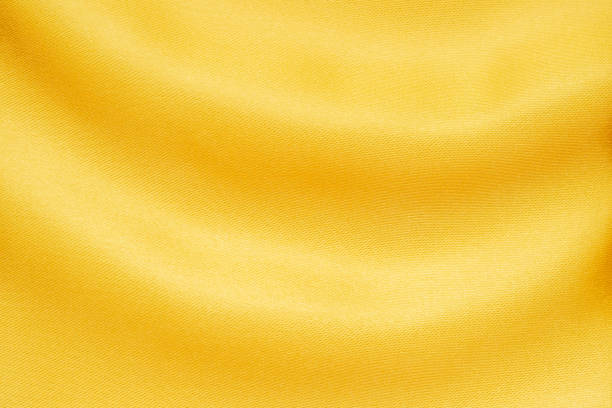 Abstract luxury gold fabric with soft wave texture background stock photo
