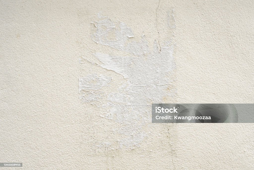Old ripped torn grunge white poster texture on concrete wall background Wall - Building Feature Stock Photo