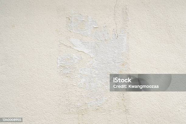 Old Ripped Torn Grunge White Poster Texture On Concrete Wall Background Stock Photo - Download Image Now