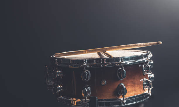 istock Close-up snare drum and drum sticks on a dark background. 1340008986