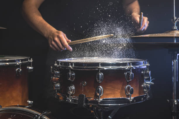 istock The drummer plays the snare drum with splashing water. 1340009009