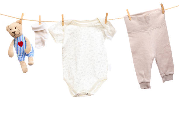 istock Baby clothes on a clothesline on white  background - Image 1340009356