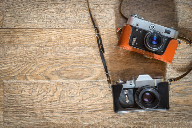 istock Two retro photo cameras on wooden background 1340010233