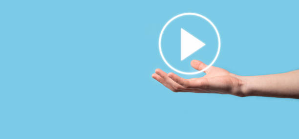istock Businessman pressing, hold play button sign to start or initiate projects.Video Play Presentation. Idea for business, technology.media player button. Play icon.Go. 1340010345