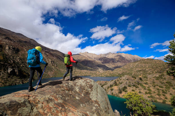 istock Two women backpackers hiking  in beautiful winter mountains 1340010511