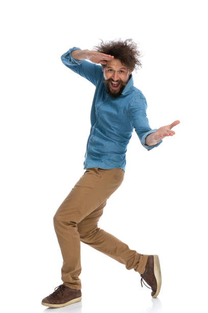 istock casual man messing around and walking to the side 1340011919