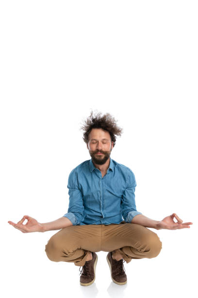 istock young casual man squatting and meditating, making yoga exercises 1340012125
