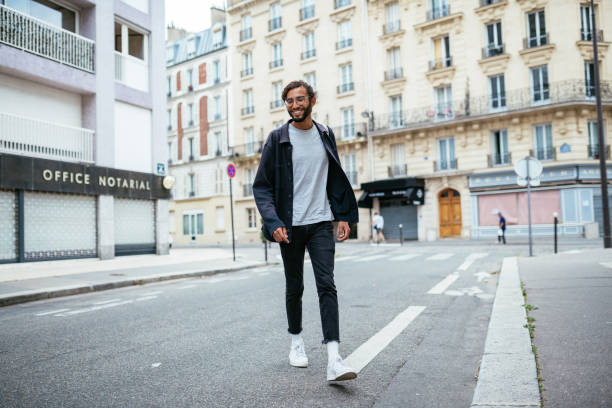 istock Young urban guy crossing the street 1340012135