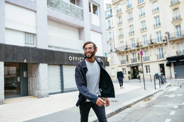 istock Young urban guy crossing the street 1340012214