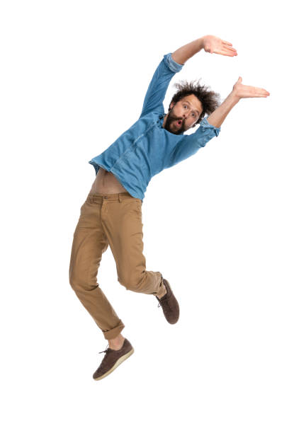 istock handsome casual man waving his body while jumping 1340012220