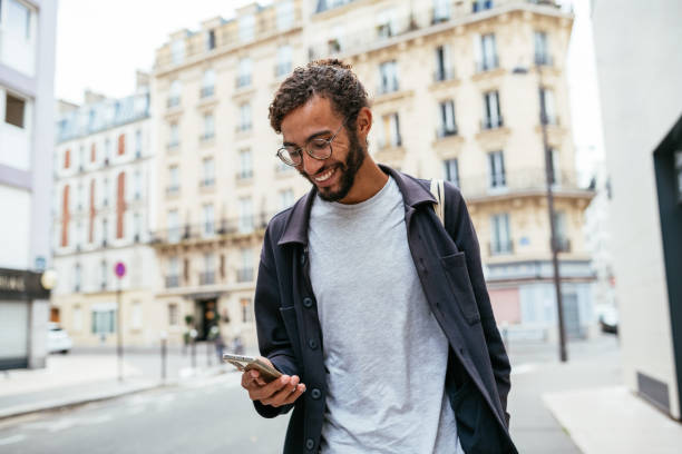 Modern young man with curly hair in the city stock photo