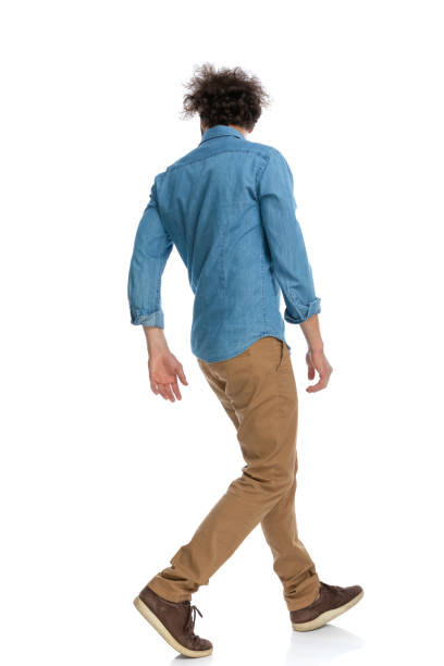 istock casual man walking one way and looking the other 1340012280