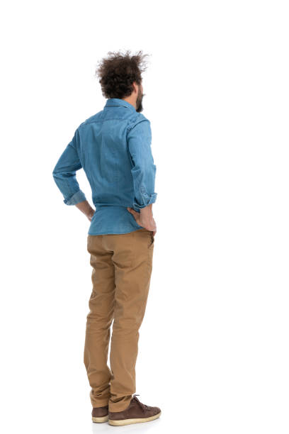 istock casual man holding hands on his hips and pondering 1340012296