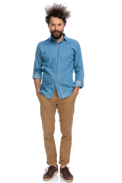 istock casual man holding his hands in pockets and standing 1340012307