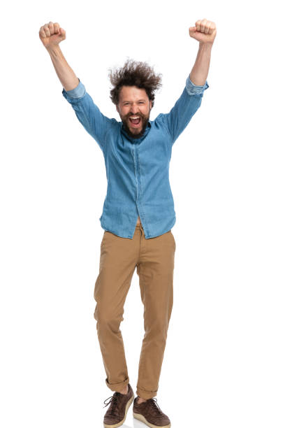 istock casual man with hands in the air is celebrating succes 1340012323