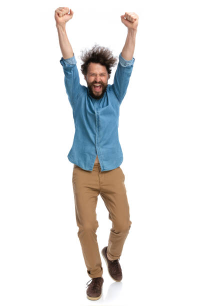 istock casual man celebrating success and walking towards the camera 1340012407