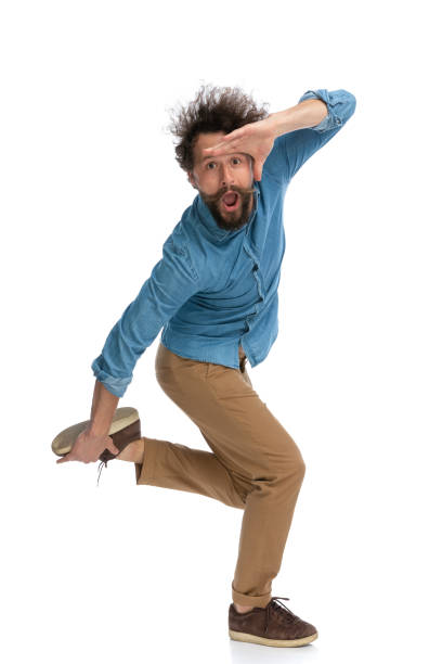 istock casual man holding his foot and protecting his eyes 1340012502