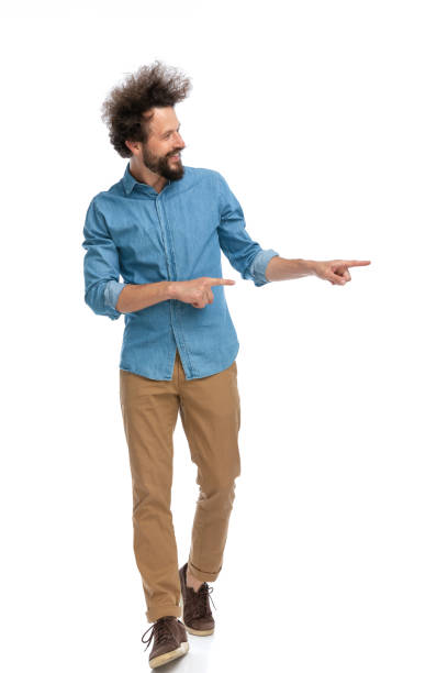 istock fashion model walking towards the camera and pointing 1340013057