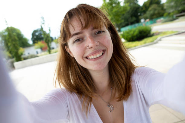 istock One young woman taking a selfie, outdoors in summer 1340013121