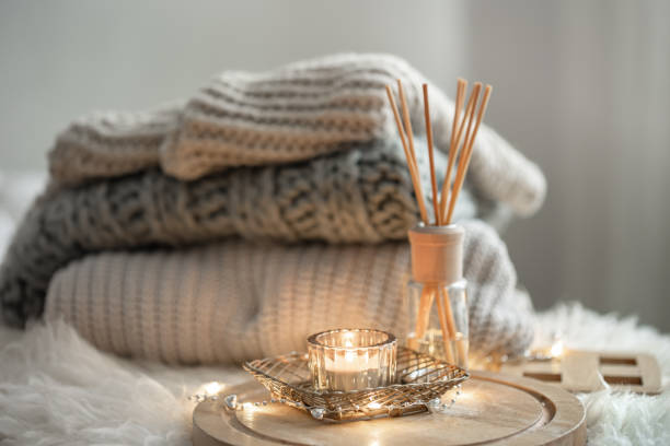 istock Cozy composition with a stack of knitted sweaters and air freshener sticks. 1340013341