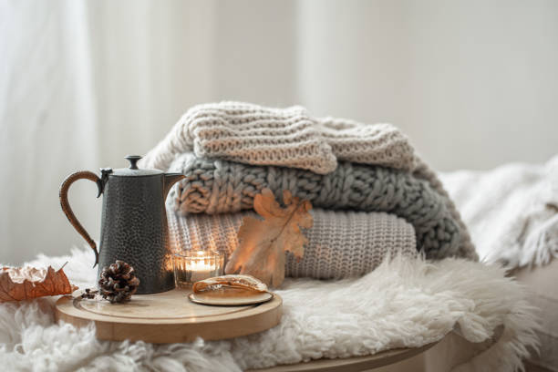 istock Cozy autumn composition with a stack of knitted sweaters and tea. 1340013342