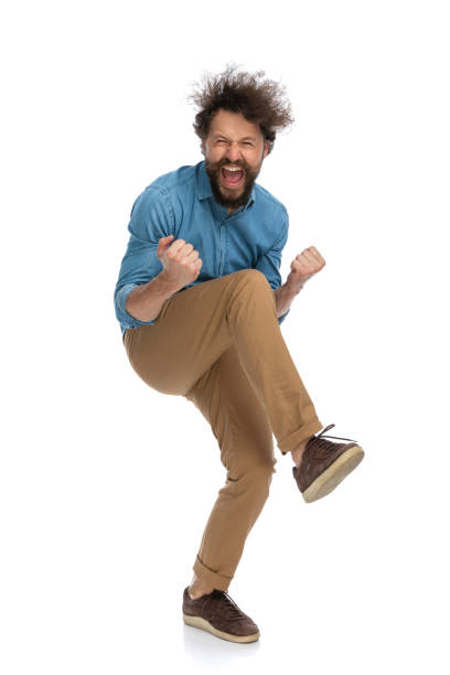 istock excited casual man raising one knee and celebrating succes 1340013663