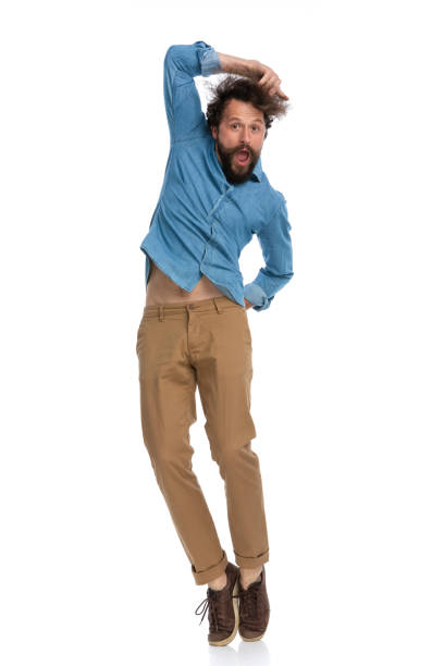 istock handsome casual man jumping with one hand on his head 1340013690