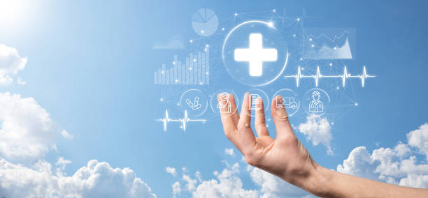 istock Businessman hold virtual plus medical network connection icons. Covid-19 pandemic develop people awareness and spread attention on their healthcare.Doctor,document,medicine,ambulance,patient icon. 1340013785
