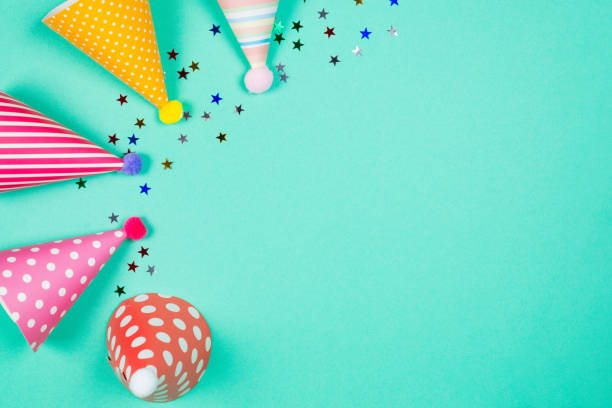 istock Colorful birthday caps on a blue background. Top view. 1340013987